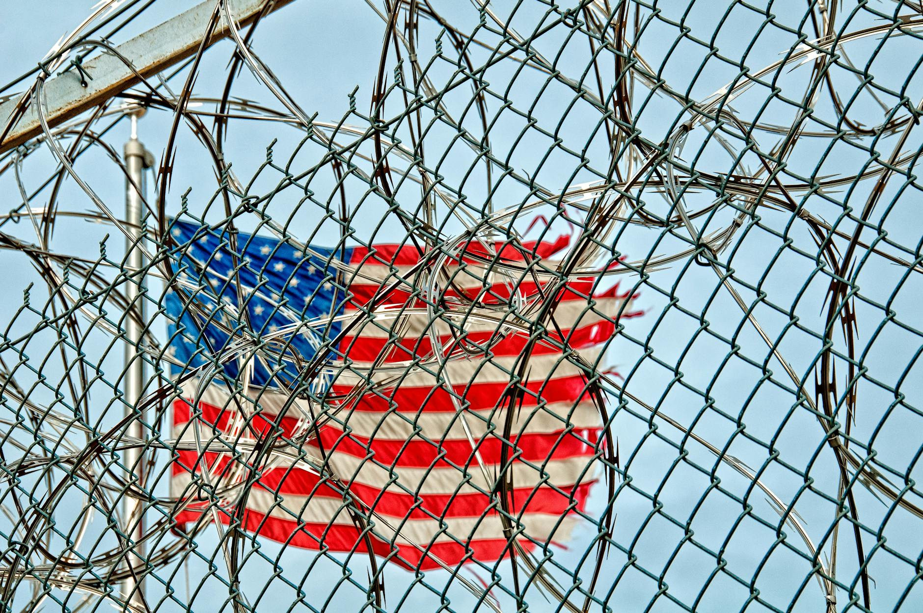 american flag on pole under blue sky during daytime